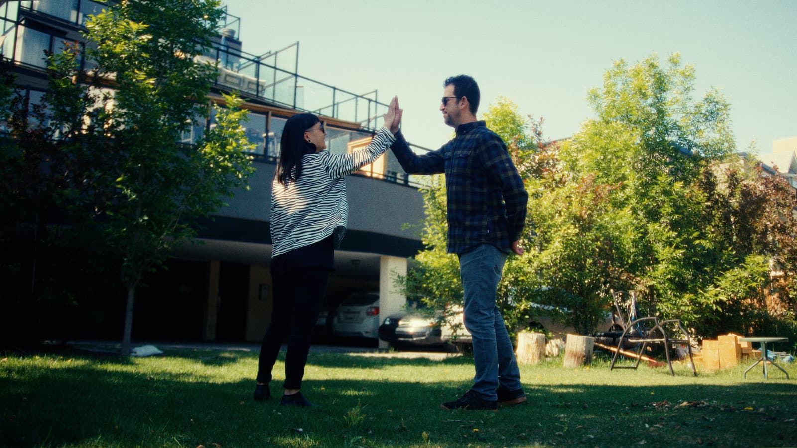 A photo of two people from Rentch Property Management high-fiving